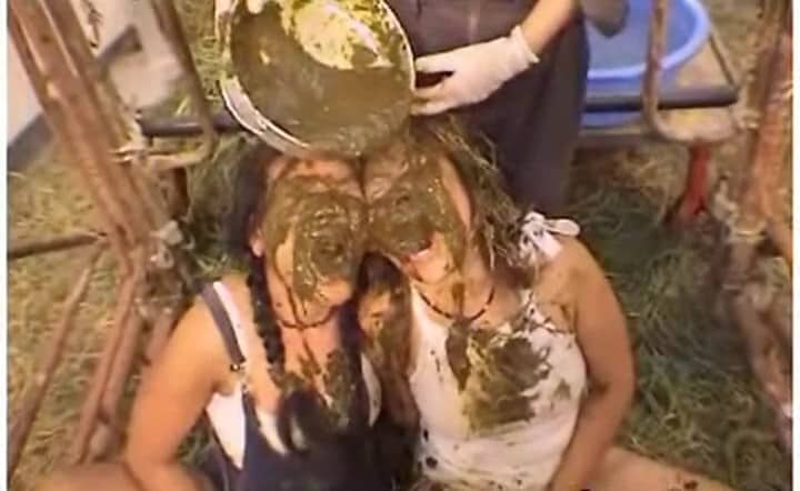 Two Asian Female Farm Hands Eating Fresh Dung